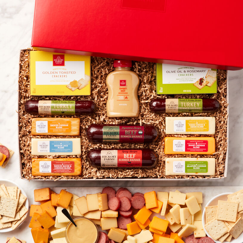 The Hearty Party Gift Box includes various beef sausages, turkey sausage, mustard, crackers, and various cheeses