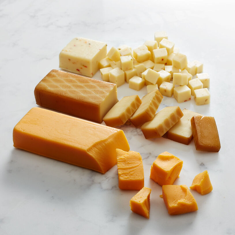 An image of Hickory Farms signature cheeses sliced on a marble surface