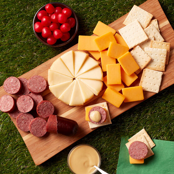 Touchdown Treats Gift Box meet and cheeses sliced and arranged on wooden board