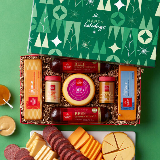 https://www.hickoryfarms.com/dw/image/v2/AAOA_PRD/on/demandware.static/-/Sites-Web-Master-Catalog/default/dw7ea2b84c/images/products/happy-holidays-summer-sausage-cheese-gift-box-new-006546-1.jpg?sw=556&sh=680&sm=fit