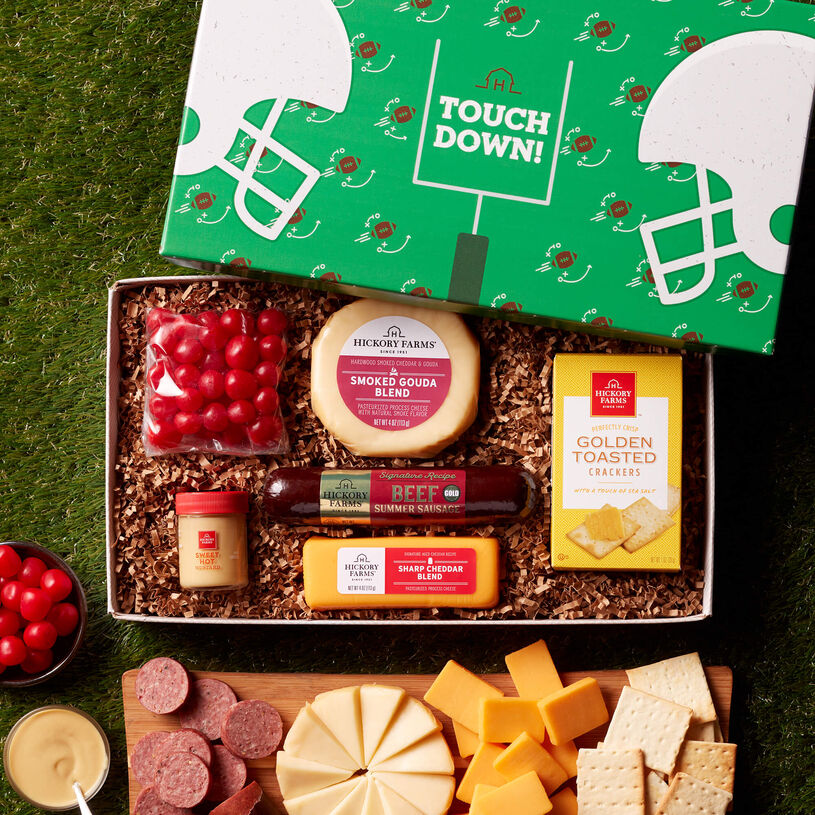 The Touchdown Treats gift box includes beef summer sausage, sweet hot mustard, cherry sour candies, and various cheeses