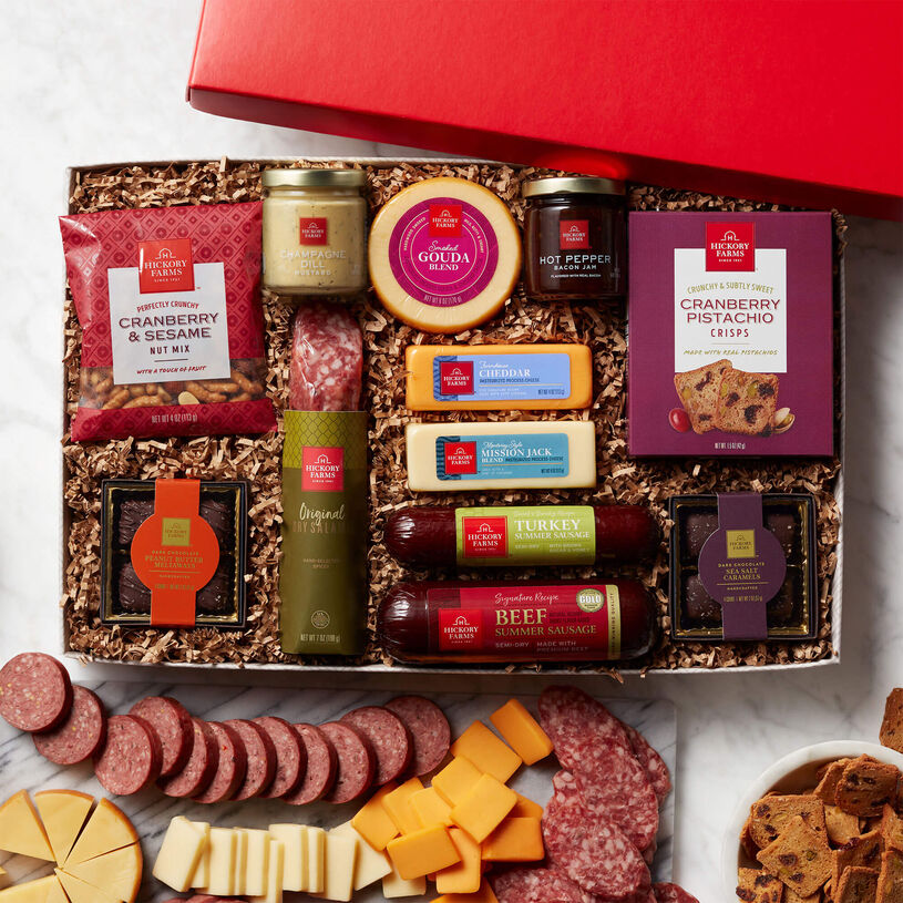 Hickory Farms Gift Box with lid off, featuring summer sausage, cheese, salami, crackers, nuts, mustards and chocolates