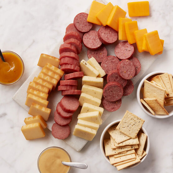 Signature Flavors Gift Basket meat and cheeses sliced and arranged on board with mustard and crackers