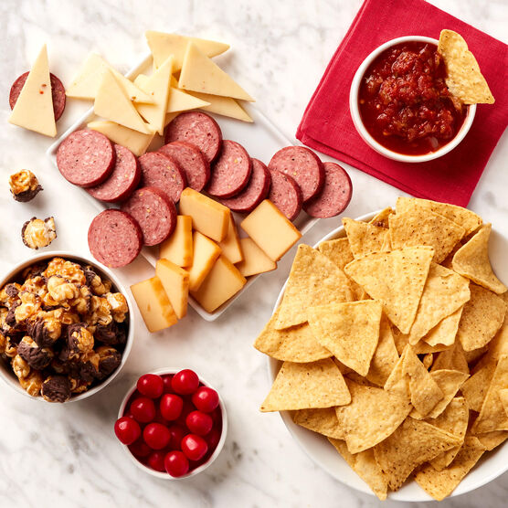 Game Night Gift Set meat and cheese sliced and arranged on tray with chips and salsa, popcorn, and candy